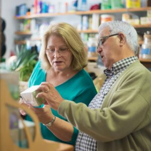 An elderly couple explores products inside a local store in Portugal, highlighting everyday life.